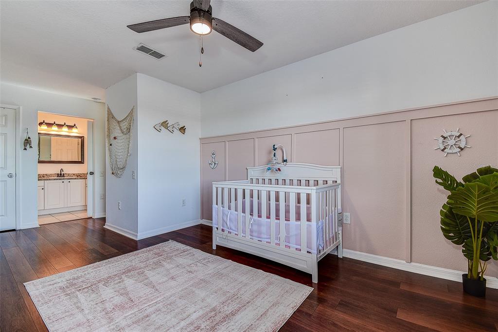 5309 Boardwalk Street Holiday, FL 34690 - Photo 37 of 50 a bedroom with a bed and wooden floor