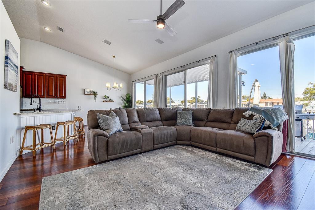 5309 Boardwalk Street Holiday, FL 34690 - Photo 4 of 50 a living room with furniture wooden floor and a flat screen tv