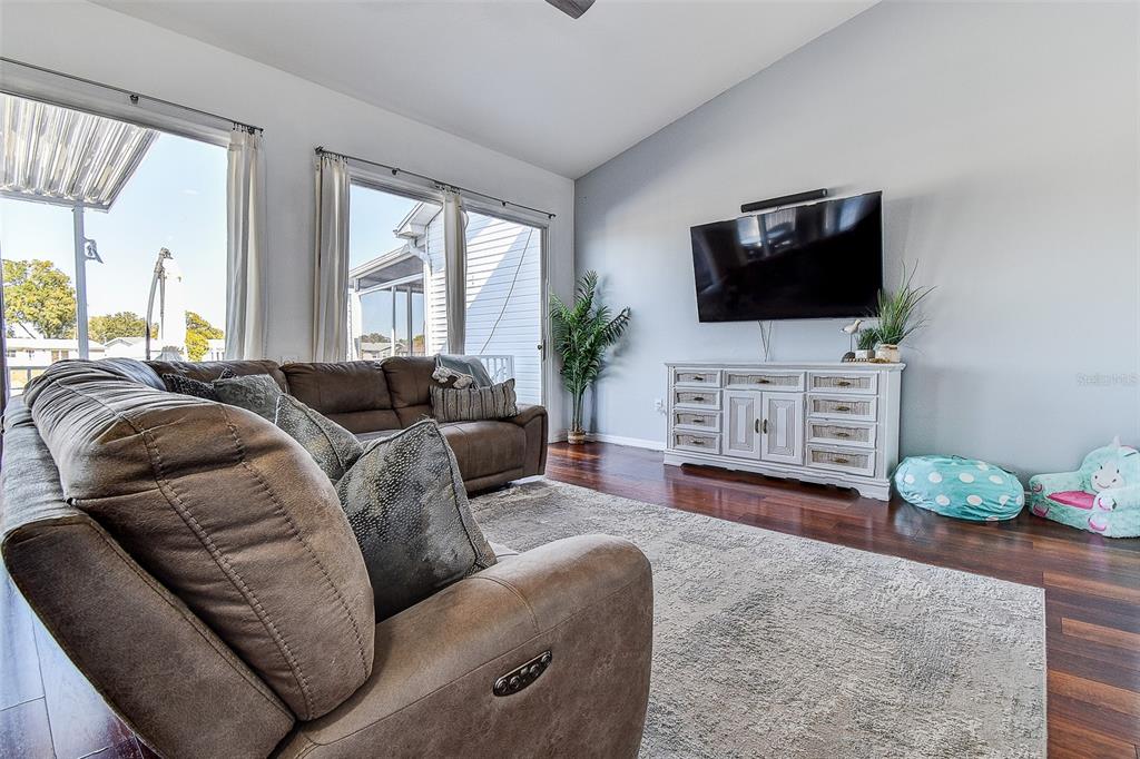 5309 Boardwalk Street Holiday, FL 34690 - Photo 7 of 50 a living room with furniture a flat screen tv and a fireplace