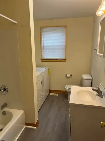 a bathroom with a sink and mirror with toilet