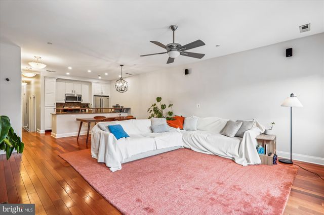 a living room with furniture and kitchen view