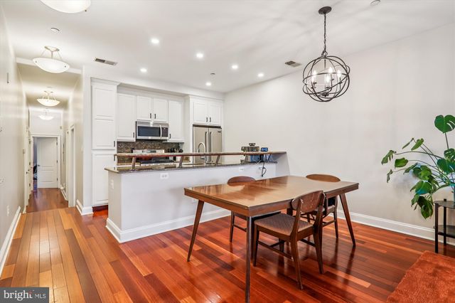 a view of a dining room with furniture wooden floor and a chandelier