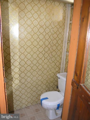 3702 Greenvale Road Baltimore, MD 21229 - Photo 1 of 15 a white toilet sitting next to a white wall