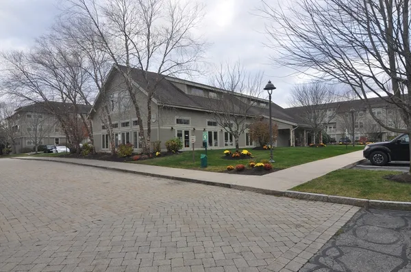 a view of a house with cars park