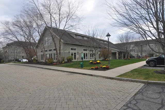 a view of a house with cars park