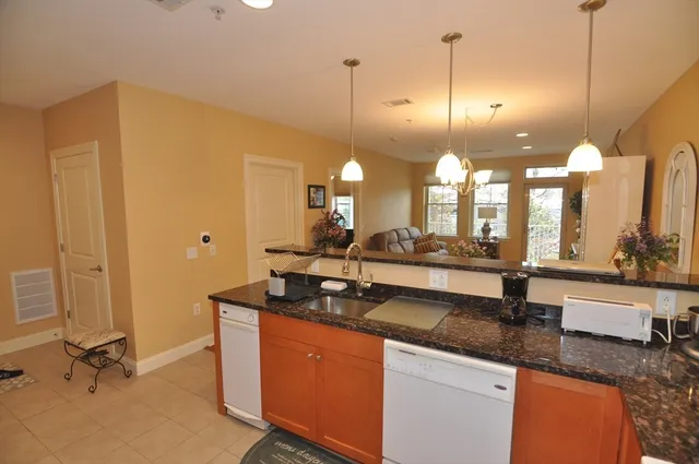 a kitchen with sink and mirror