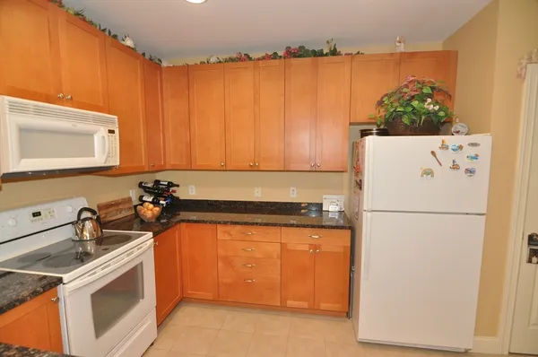 a white refrigerator freezer sitting inside of a kitchen