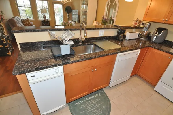 a kitchen with sink refrigerator and stove