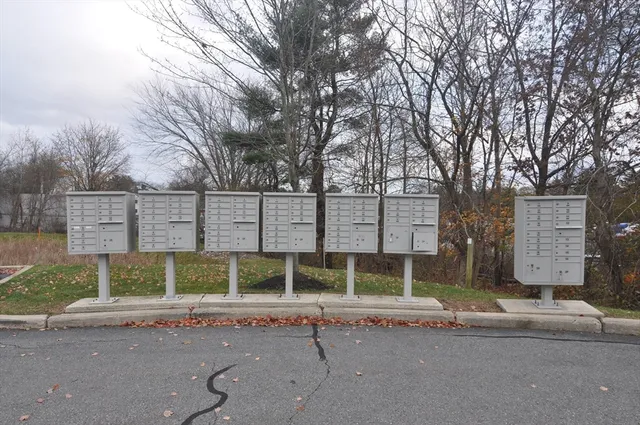 a view of a brick house with large windows and a table and chairs