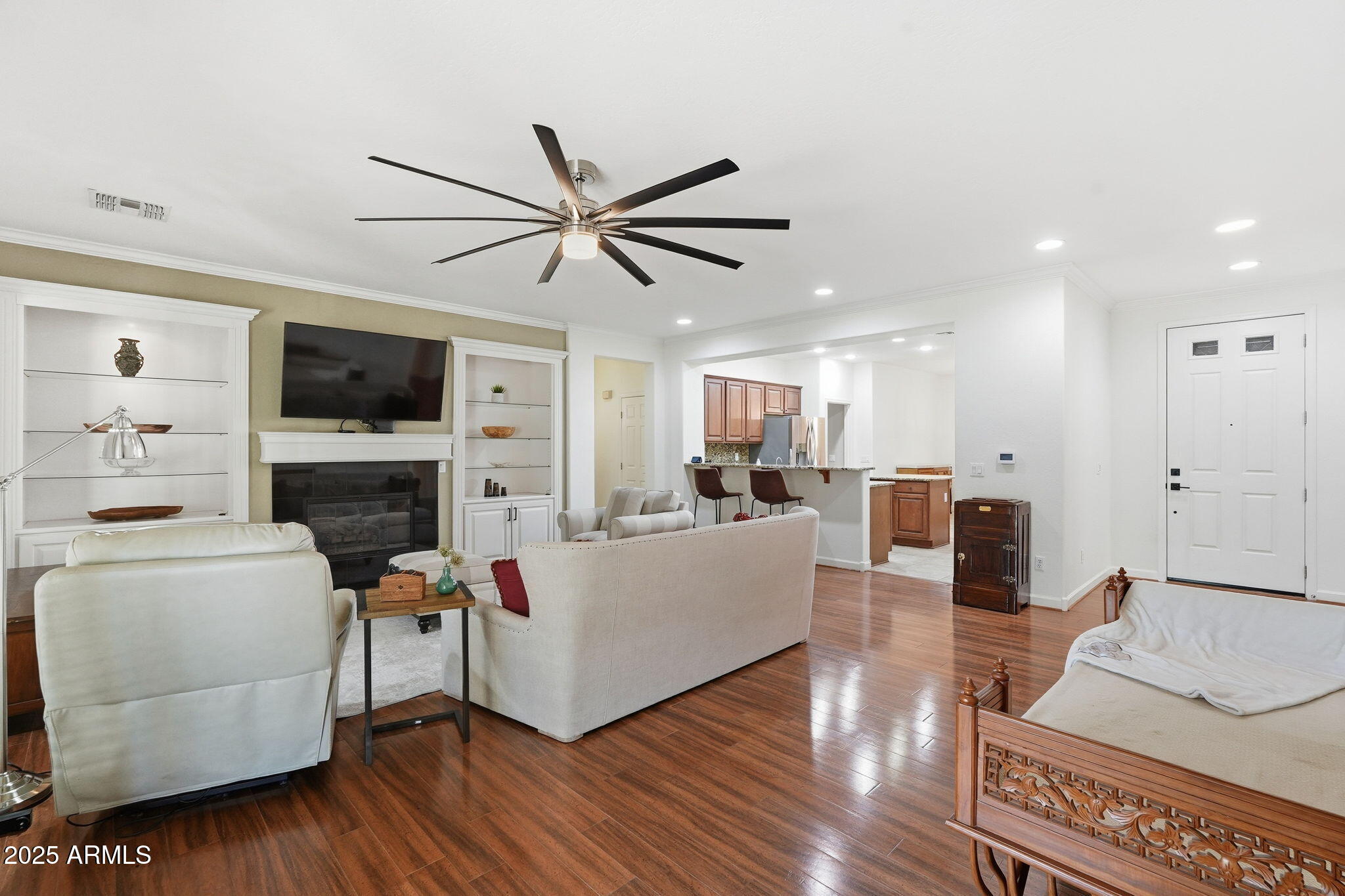 5161 North Scottsdale Road Eloy, AZ 85131 - Photo 10 of 58 a living room with furniture a fireplace and a flat screen tv