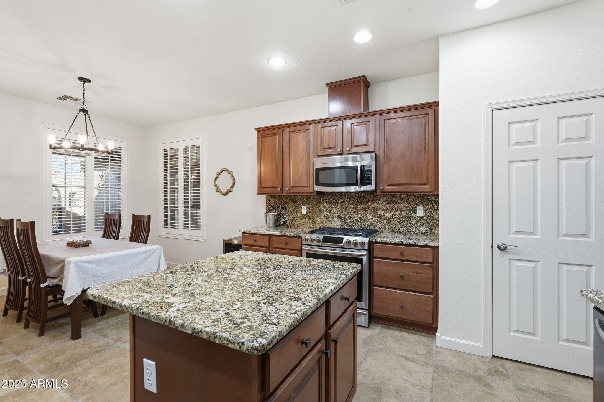 5161 North Scottsdale Road Eloy, AZ 85131 - Photo 14 of 58 a kitchen with kitchen island granite countertop a stove and a center island