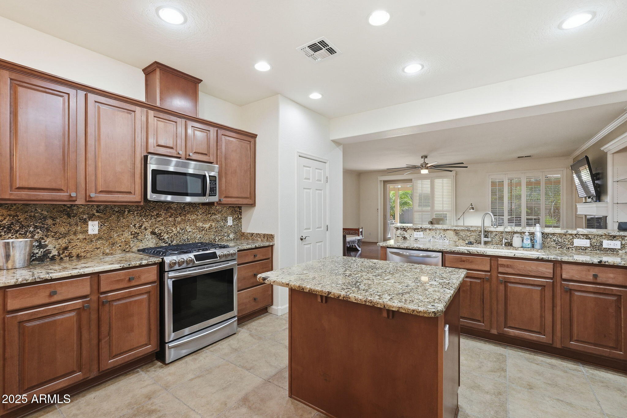 5161 North Scottsdale Road Eloy, AZ 85131 - Photo 15 of 58 a kitchen with stainless steel appliances granite countertop a sink stove and microwave