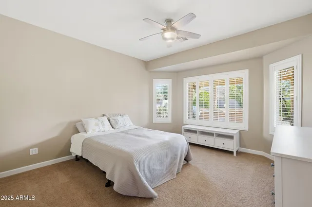 a bedroom with a bed and a chair