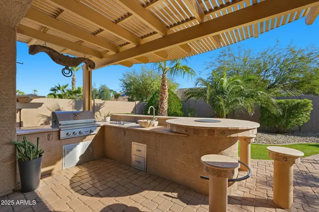 a view of a patio with table and chairs potted plants with wooden floor