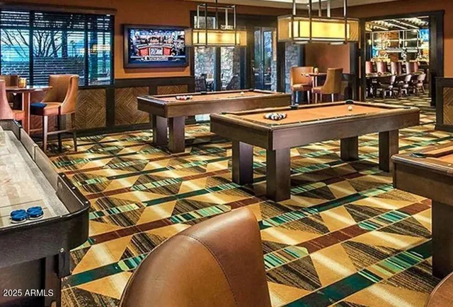 a view of a swimming pool with a lawn chairs under an umbrella