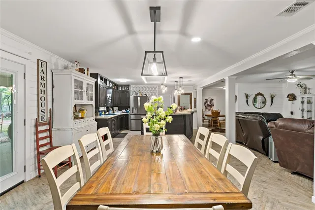 a dining room with furniture a rug and wooden floor