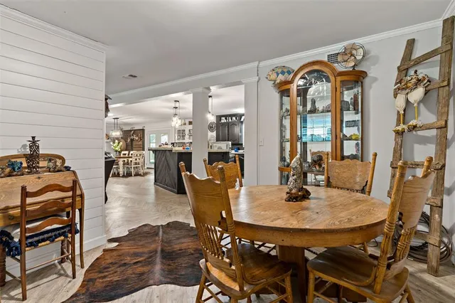 a dining room with furniture and wooden floor