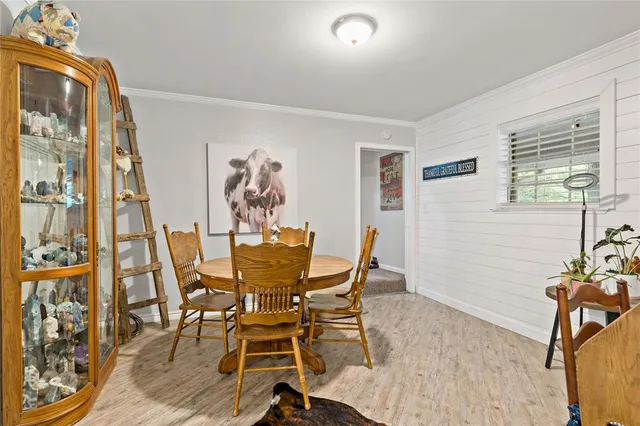 a view of a dining room with furniture and a window