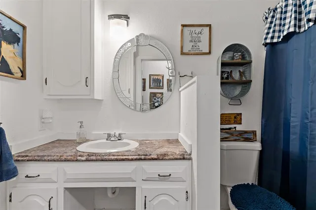 a bathroom with a granite countertop and sink