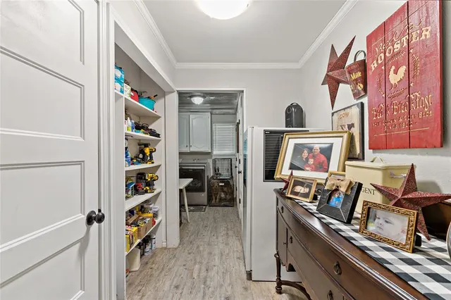 a view of a room with shelves and wooden floor
