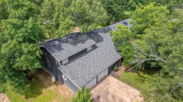 aerial view of a house with a yard and garden