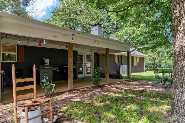 a view of a house with backyard porch and glass windows