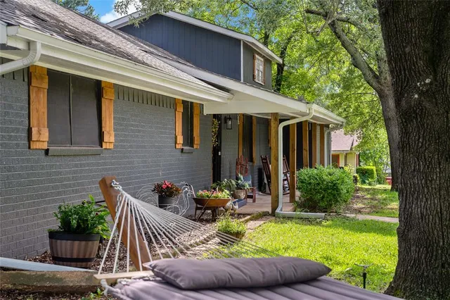 a view of house with backyard outdoor seating and green space