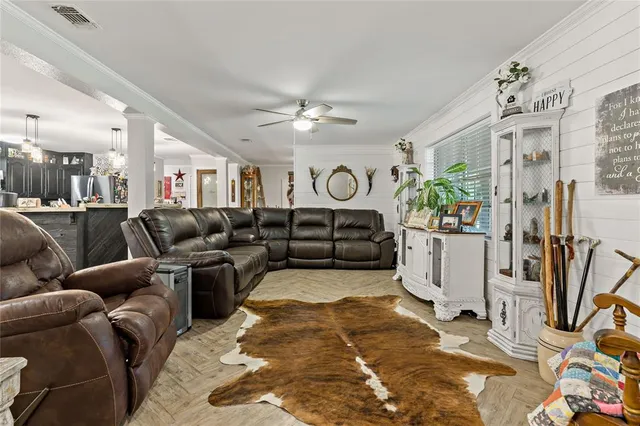 a living room with furniture ceiling fan and a rug