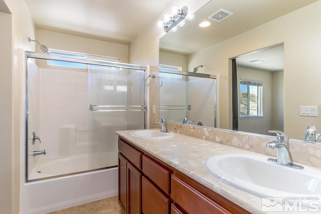 1863 Star Bright Way Reno, NV 89523 - Photo 11 of 22 a bathroom with a granite countertop sink a shower and a mirror