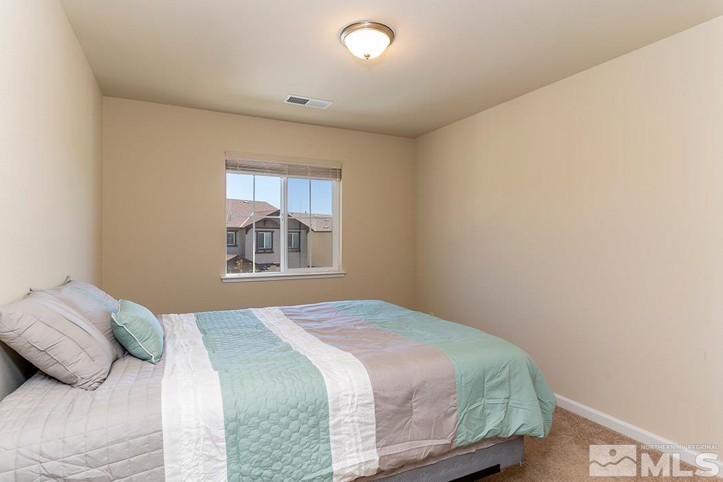 1863 Star Bright Way Reno, NV 89523 - Photo 13 of 22 a bedroom with a bed and a window