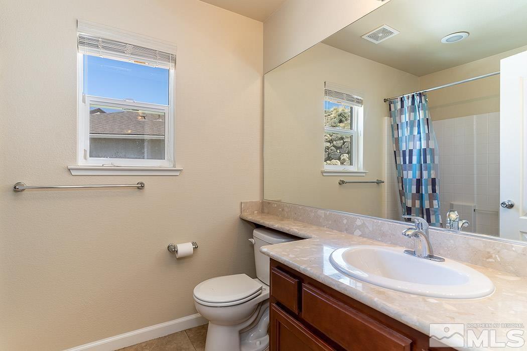1863 Star Bright Way Reno, NV 89523 - Photo 15 of 22 a bathroom with a granite countertop sink toilet and mirror