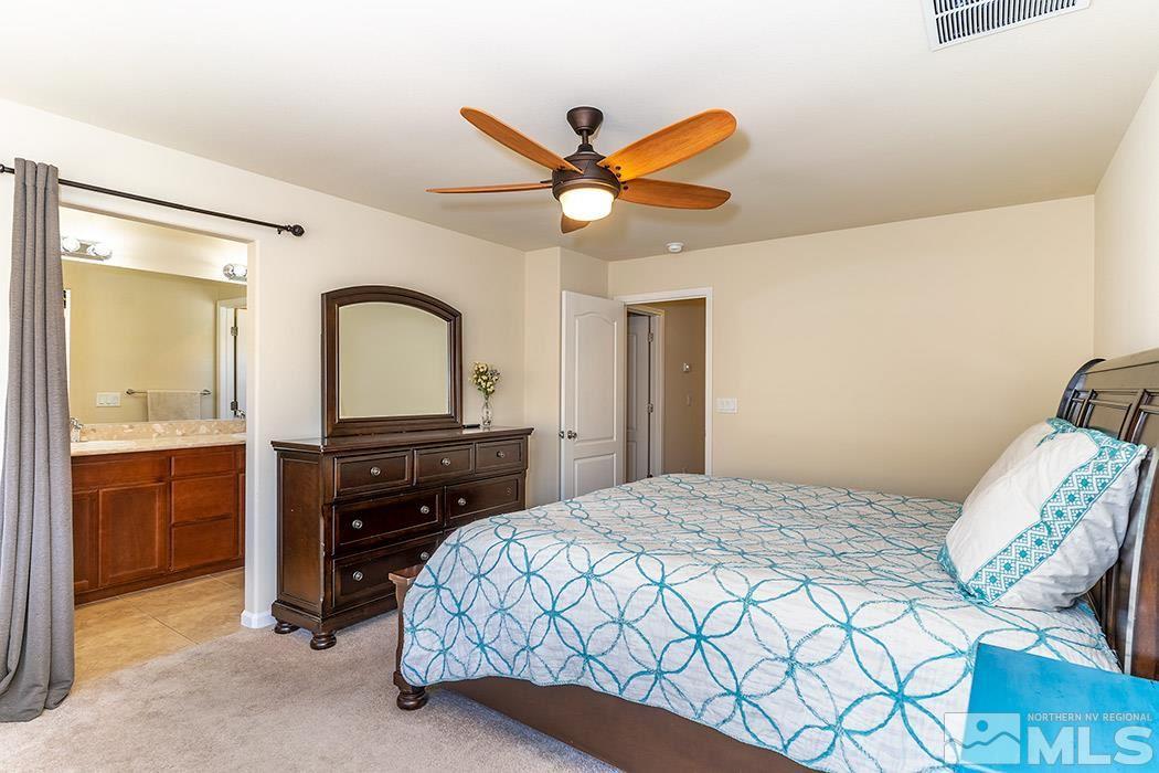 1863 Star Bright Way Reno, NV 89523 - Photo 8 of 22 a bedroom with a bed and a chandelier