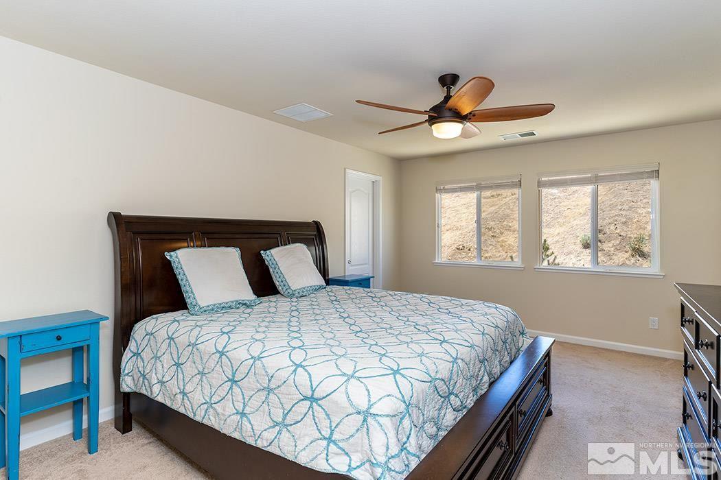 1863 Star Bright Way Reno, NV 89523 - Photo 9 of 22 a bedroom with a large bed and a window