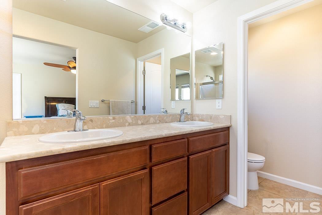 1863 Star Bright Way Reno, NV 89523 - Photo 10 of 22 a bathroom with a granite countertop sink mirror and toilet