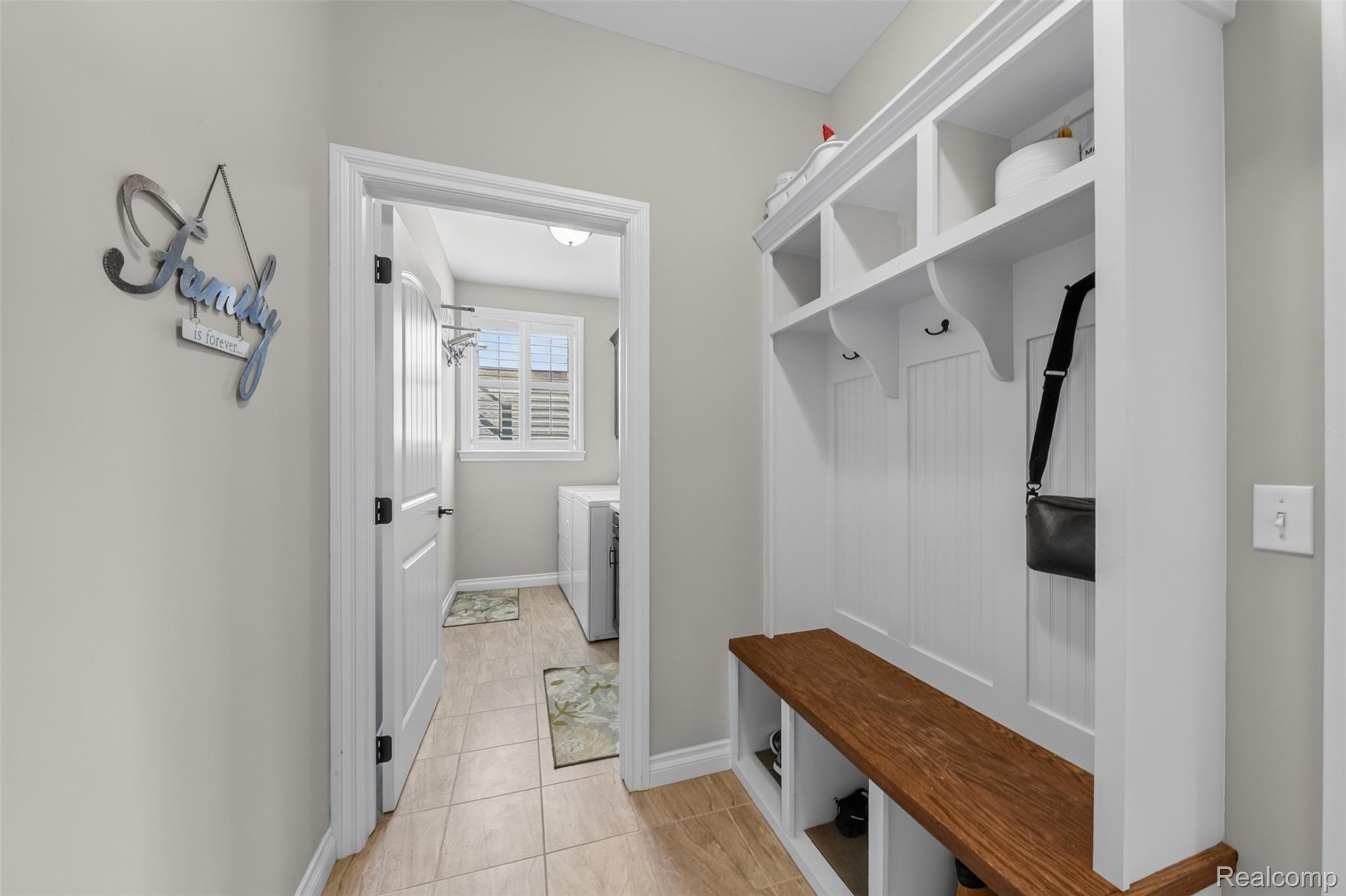 2531 Walnut View Drive Howell, MI 48855 - Photo 19 of 34 Entryway featuring a built-in white mudroom bench with a wood-finish seat, cubbies, and hooks