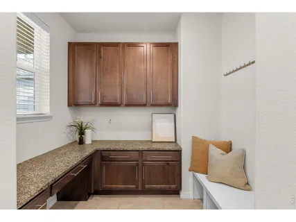 a kitchen with granite countertop cabinets stainless steel appliances and a sink