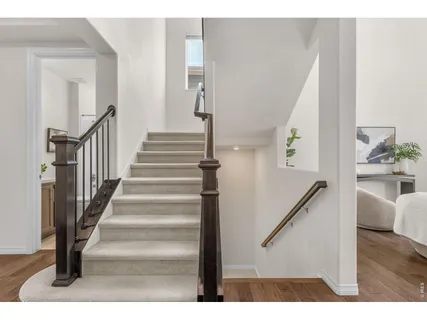 a view of entryway and hall with wooden floor