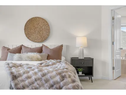 a bedroom with a bed and a lamp