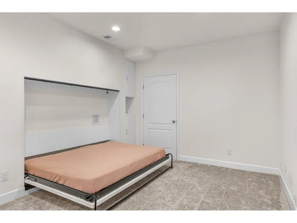 a bedroom with a bed and a shower