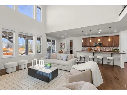 a living room with furniture and kitchen view