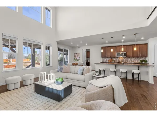 a living room with furniture and kitchen view