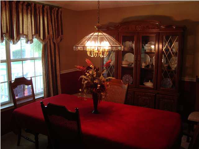 515 Ridge Lake Road Crestview, FL 32536 - Photo 13 of 25 a view of a dining room with furniture and chandelier