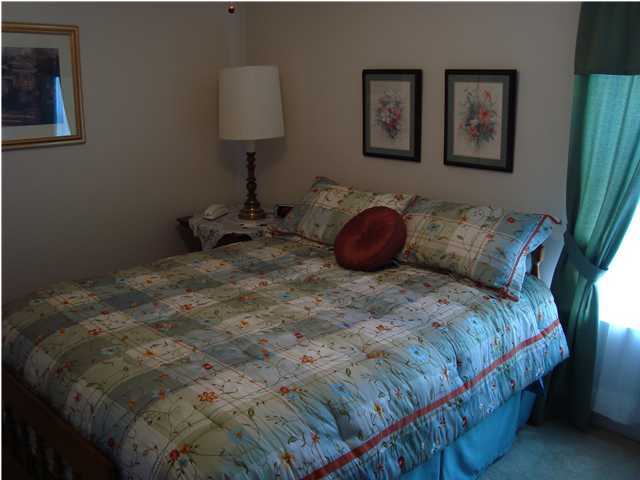 515 Ridge Lake Road Crestview, FL 32536 - Photo 21 of 25 a bedroom with a bed and a lamp on the dresser