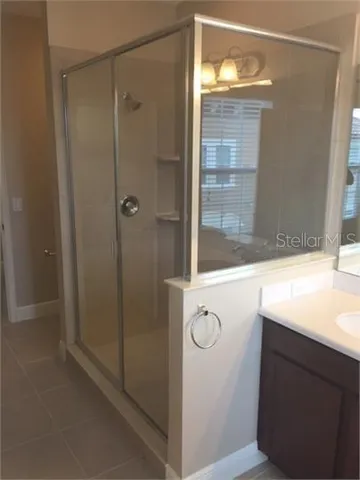 a bathroom with a shower and a sink