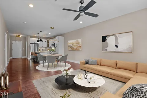 a view of empty room with wooden floor and ceiling fan