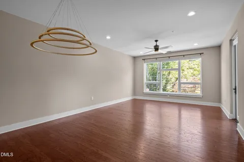 a view of a workspace with furniture and wooden floor