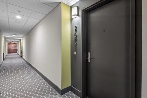a kitchen with stainless steel appliances granite countertop a sink and a stove top oven with wooden floor