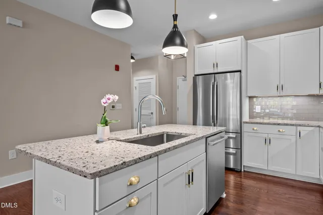 a kitchen with stainless steel appliances granite countertop a sink and a stove