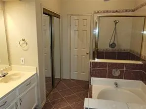 a bathroom with a tub a sink and a shower