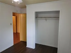 a view of walk in closet with empty racks